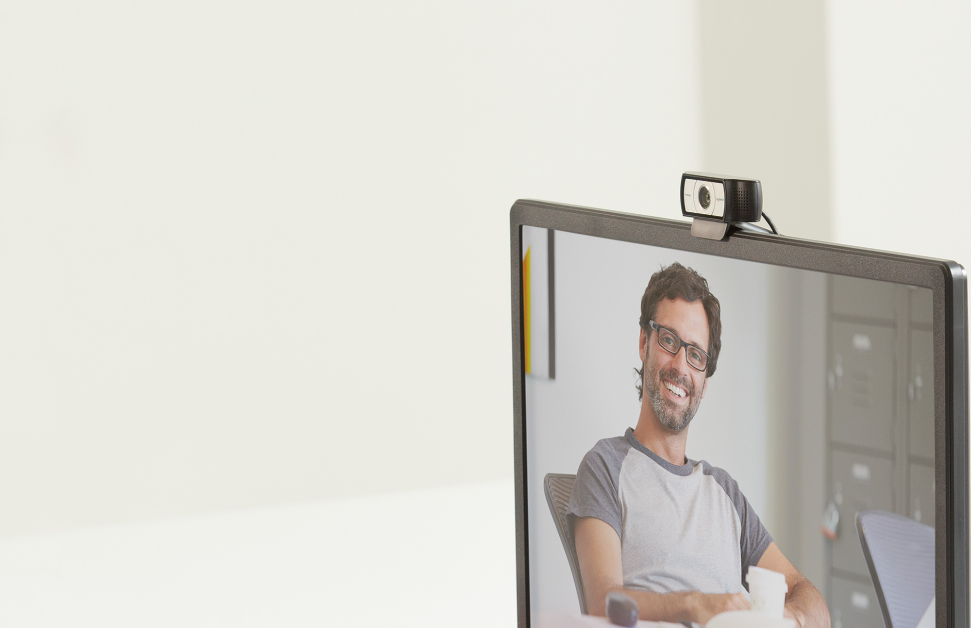 Woman in front of monitor with C930e in video conference call.